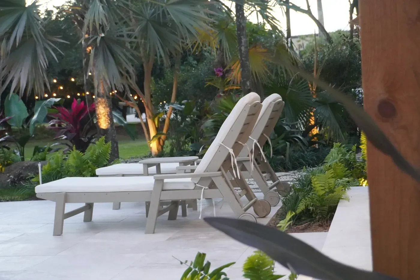 Landscape lighting illuminating a Keys property at dusk