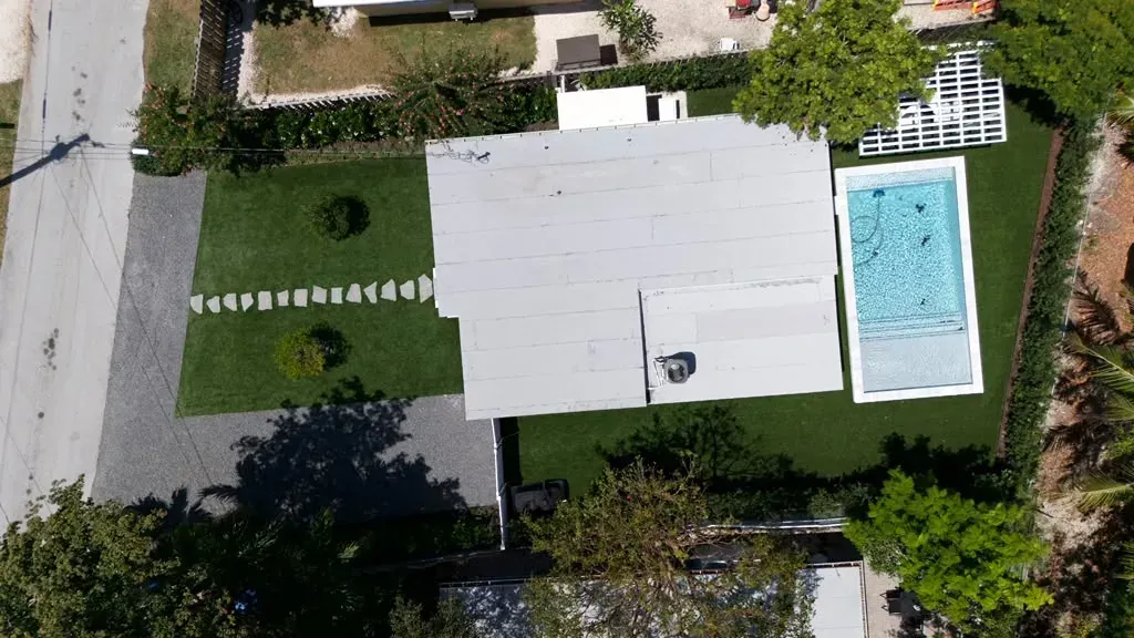 Aerial view of an artificial turf lawn, stepping-stone path and pool at a Florida Keys home